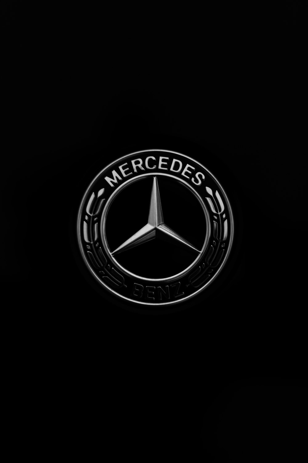a mercedes logo on a black background photo – Free Symbol Image on Unsplash
