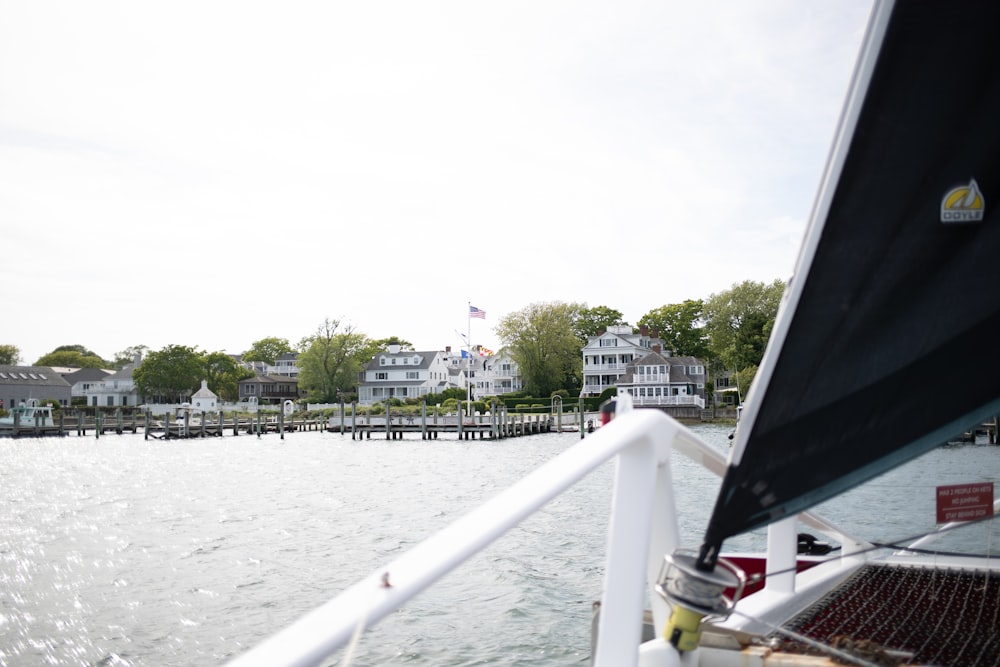 a boat traveling down a river next to houses