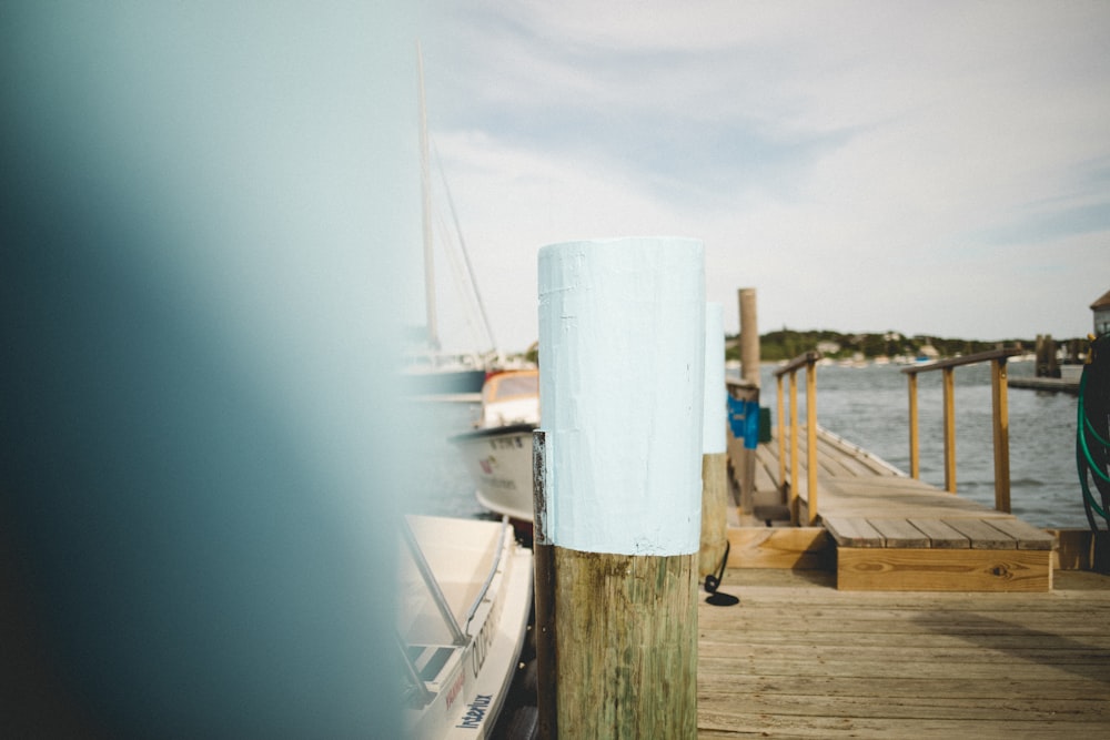 a wooden dock with a boat docked at the end