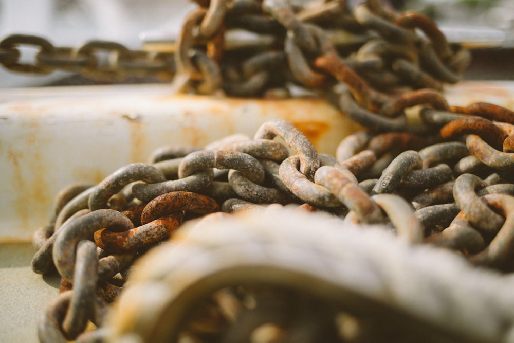 a pile of rusty chains sitting on top of a table