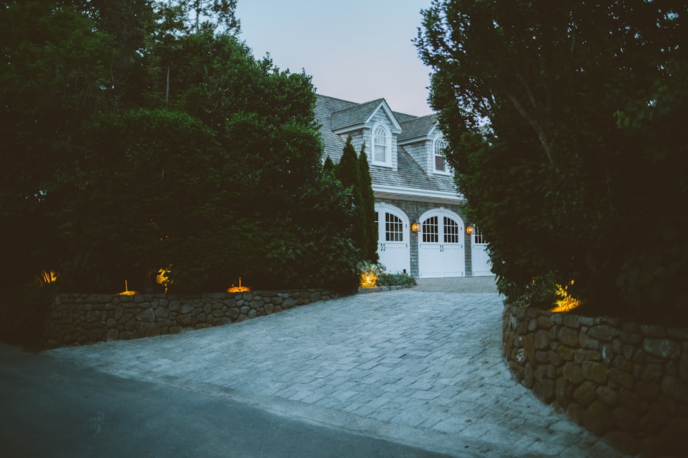 a large house with a driveway surrounded by trees