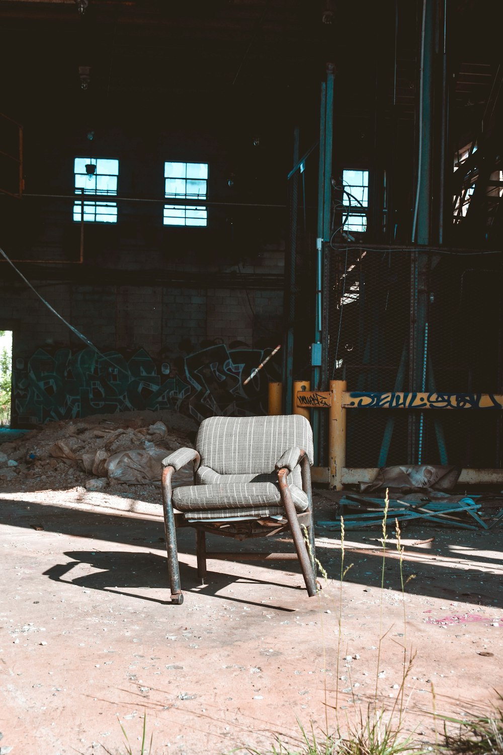 a chair that is sitting in the dirt