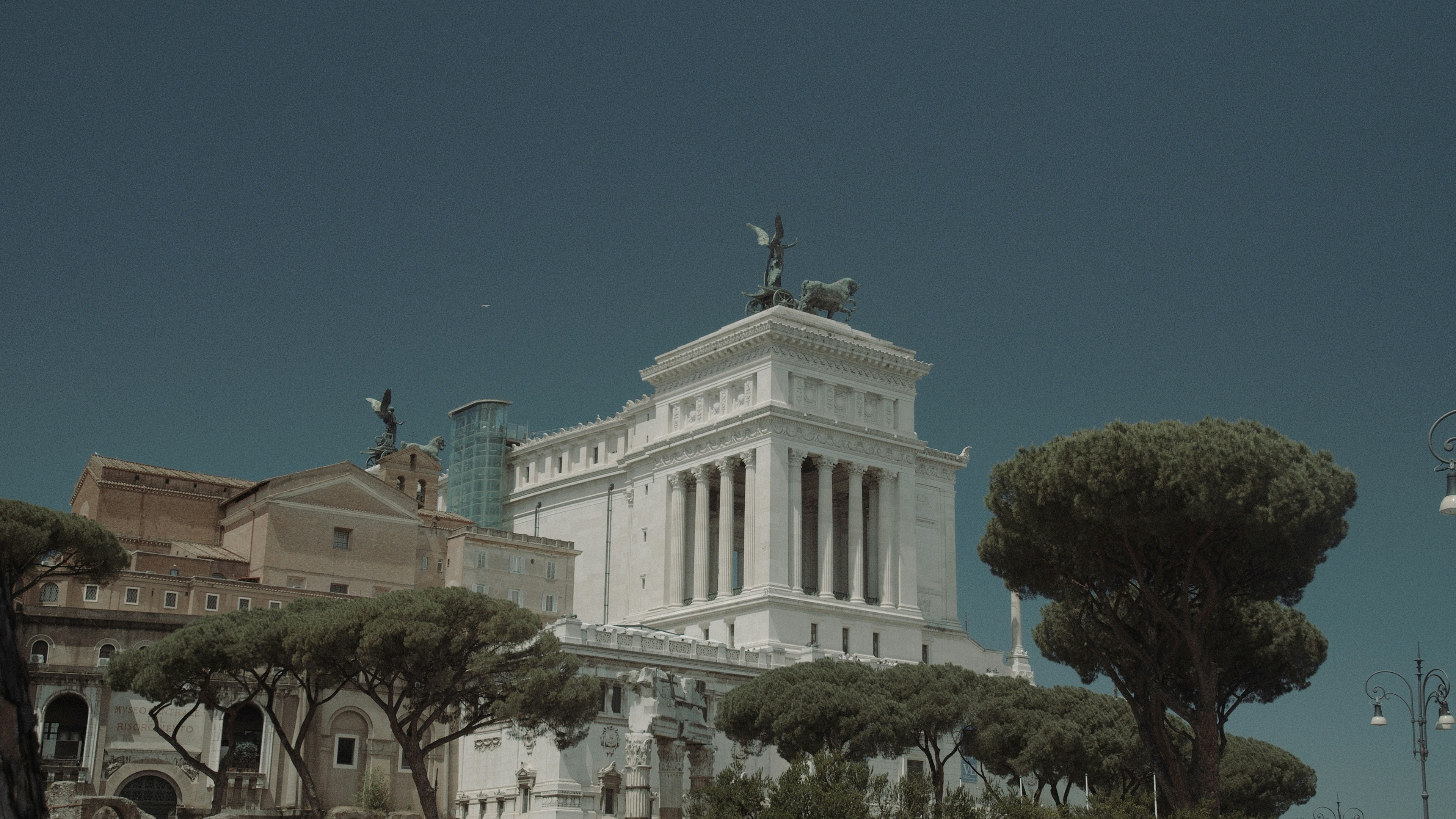 a large white building with a statue on top of it