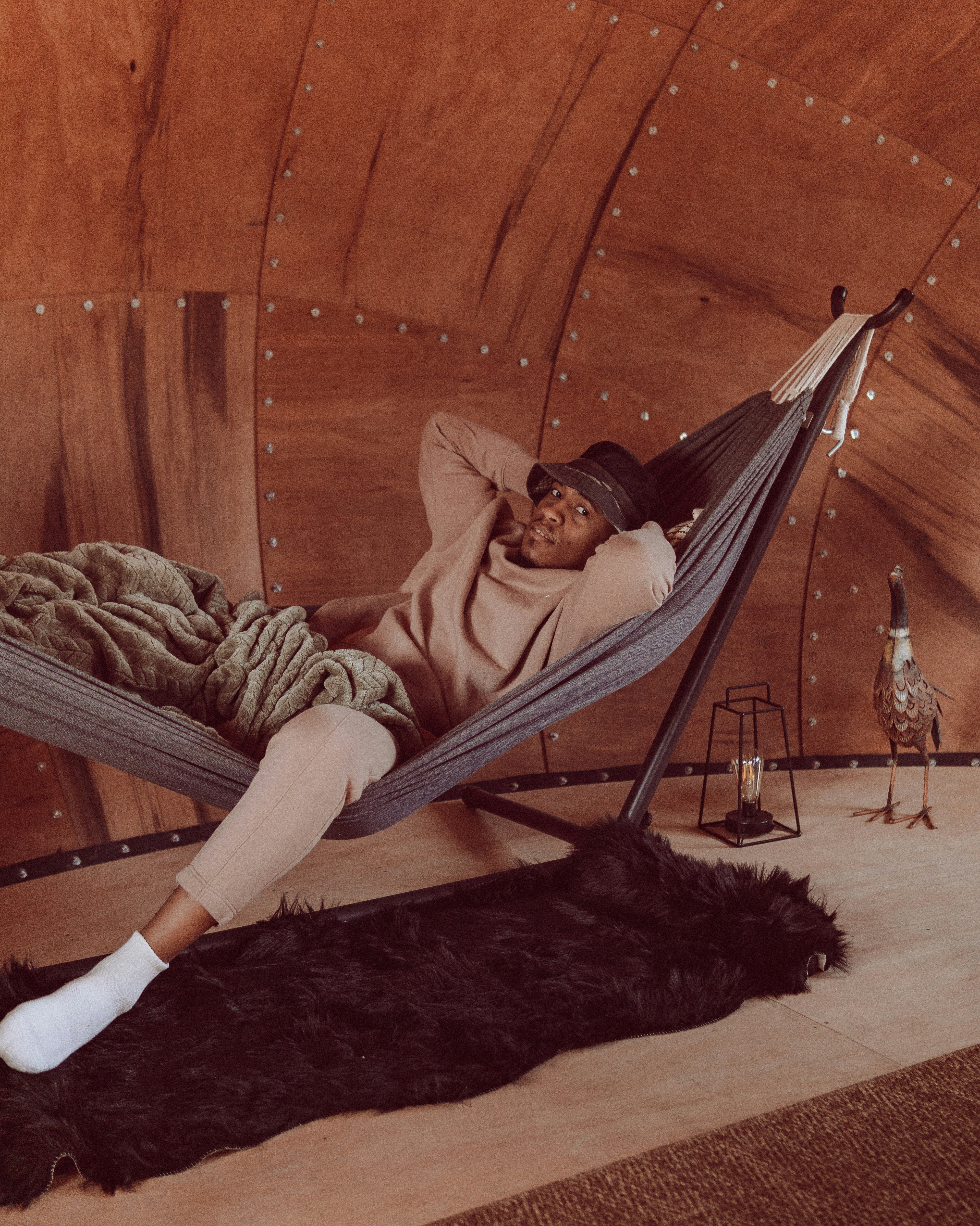 a woman laying in a hammock in a room