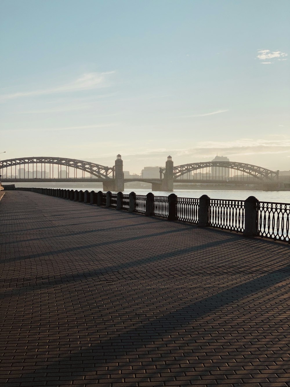 a bridge over a body of water with a bridge in the background