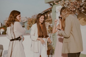 A group of fashionable women enjoying a sunny outdoor setting