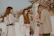 A stylish group of women enjoying a luxurious outdoor event with elegant decor and scenic views.