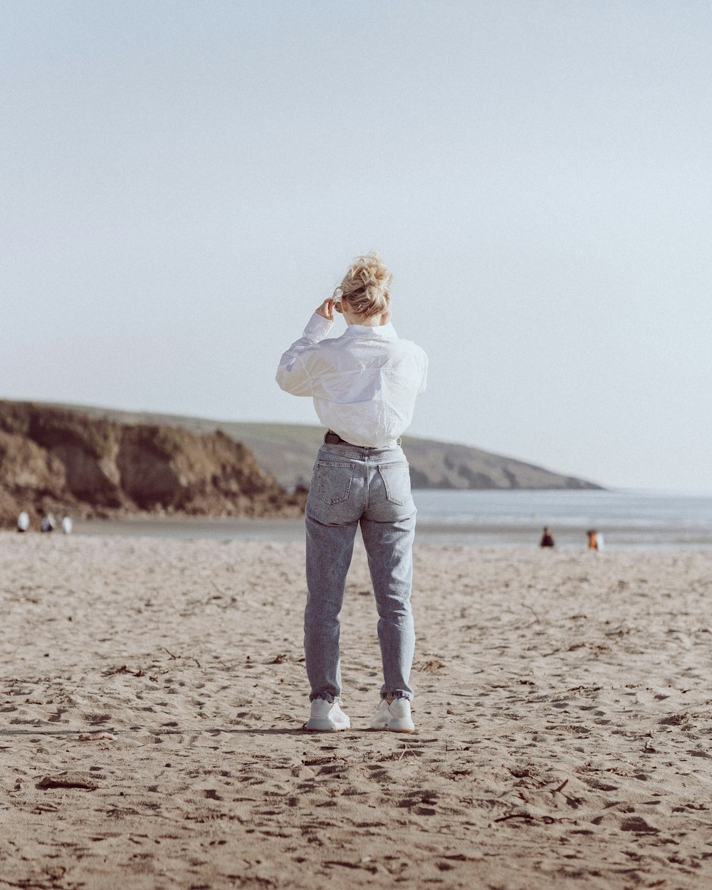 a man standing on top of a sandy beach