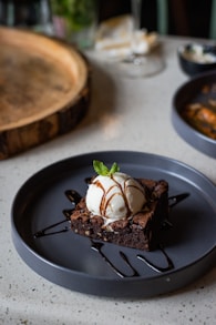 a piece of chocolate cake with ice cream on top