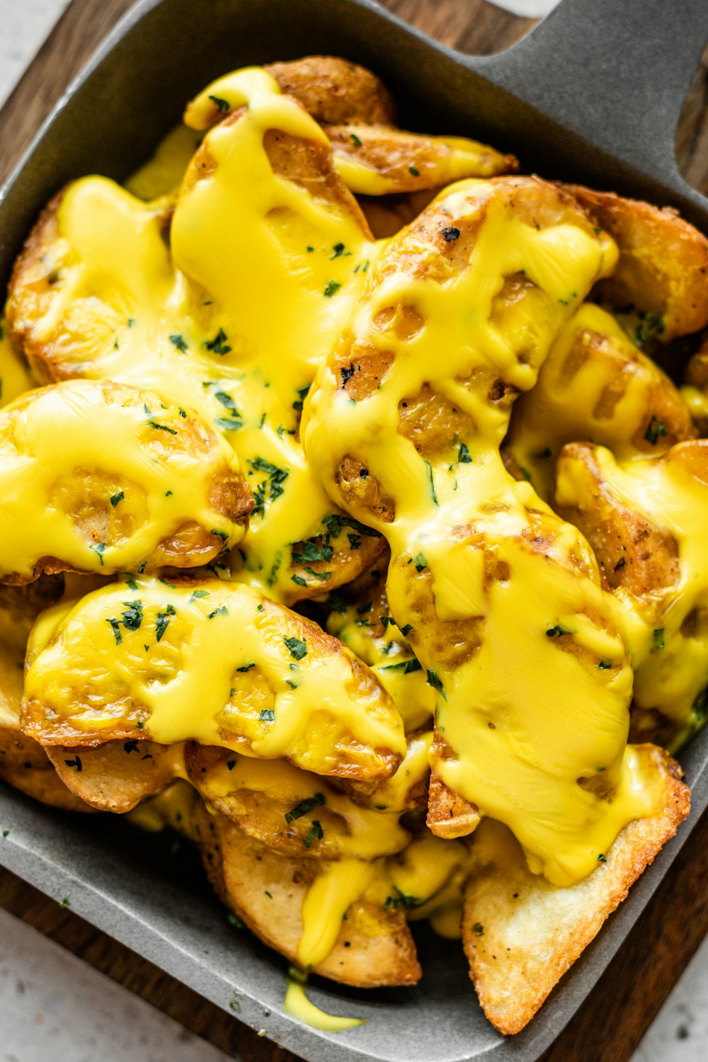 a pan filled with cheesy bread covered in cheese