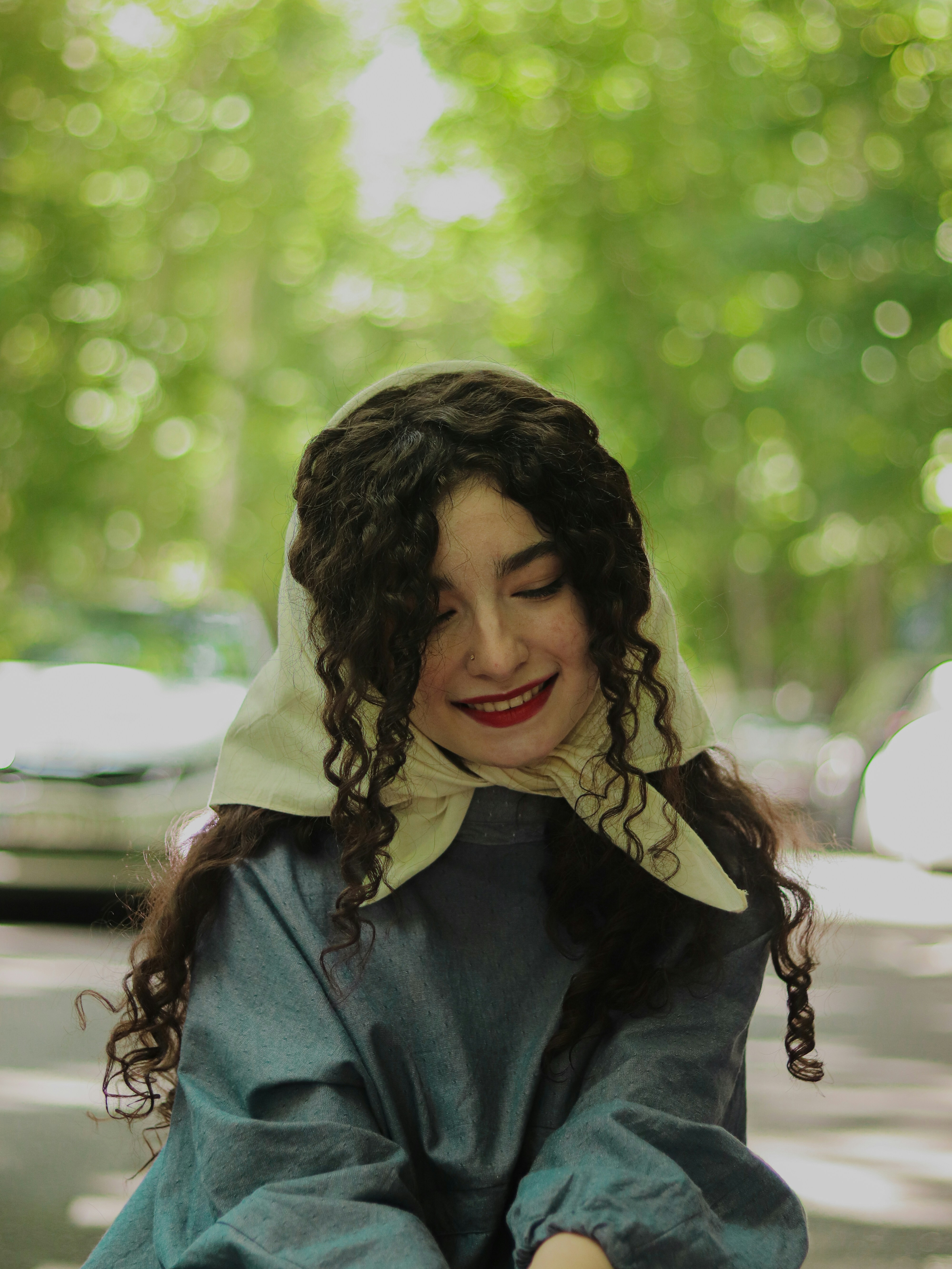 a woman in a blue dress is holding a cell phone