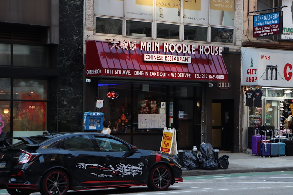 a car parked on the side of the road in front of a building