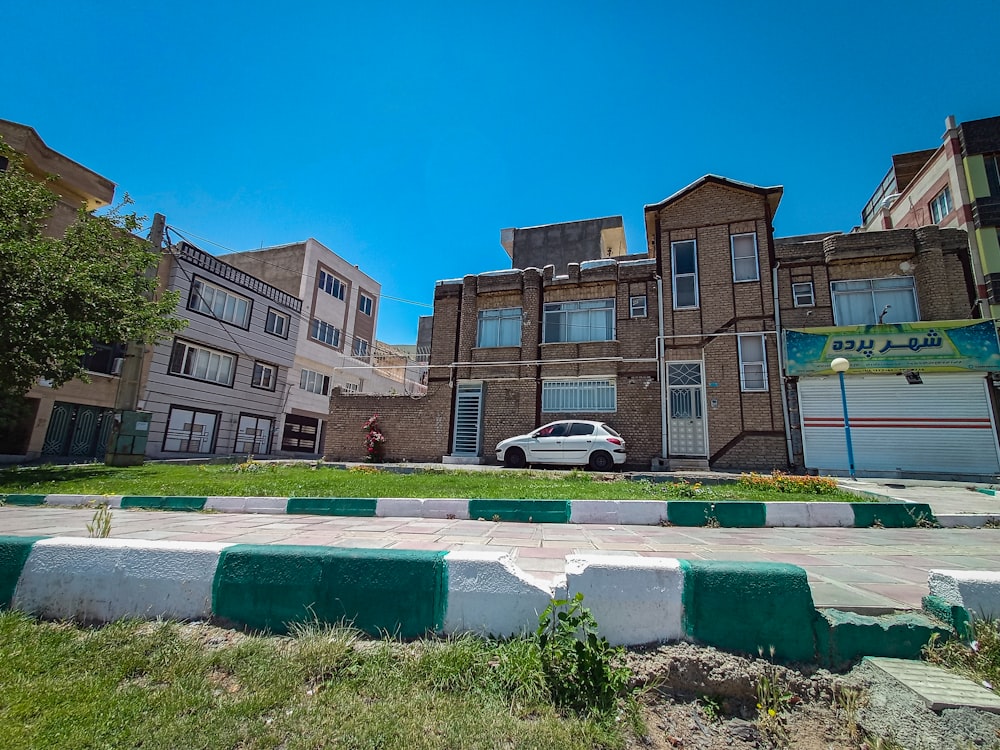 a white car parked in front of a building