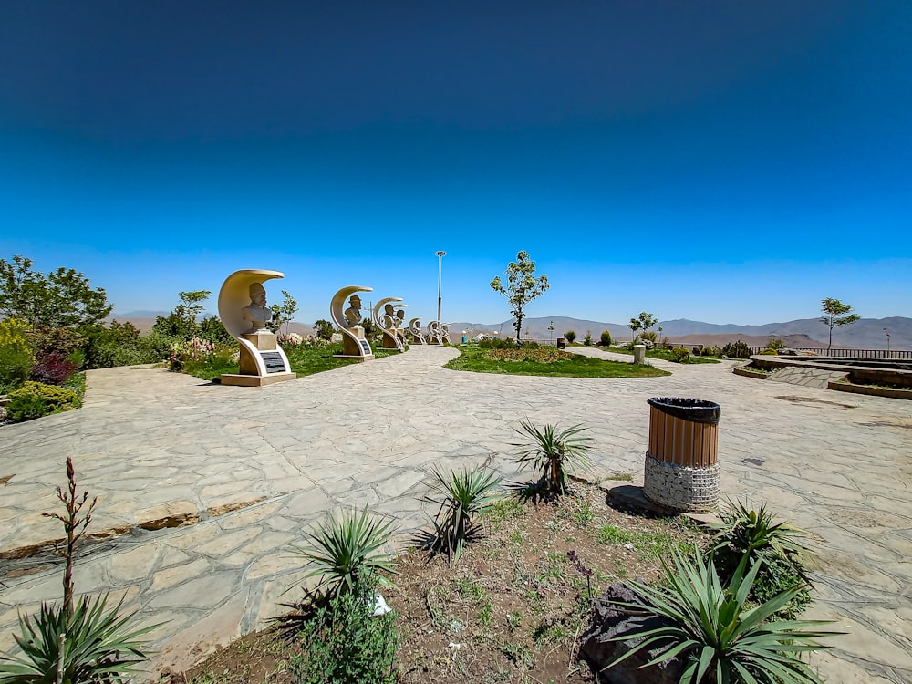 a park with a lot of plants and sculptures