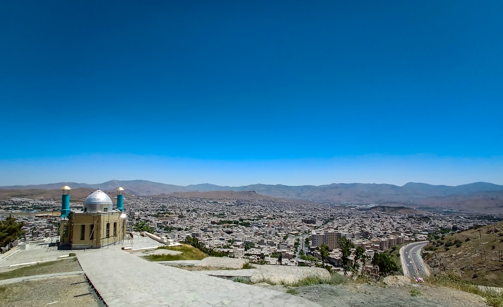 a scenic view of a city from a hill