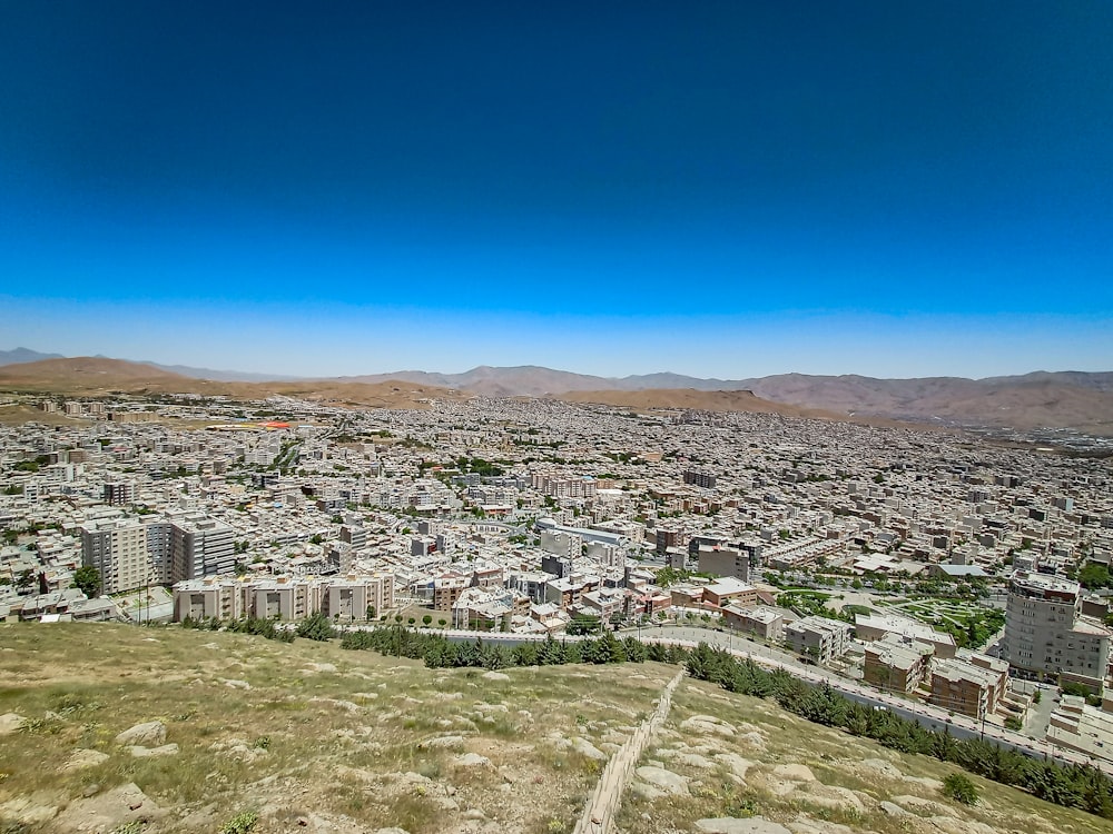 an aerial view of a city with mountains in the background