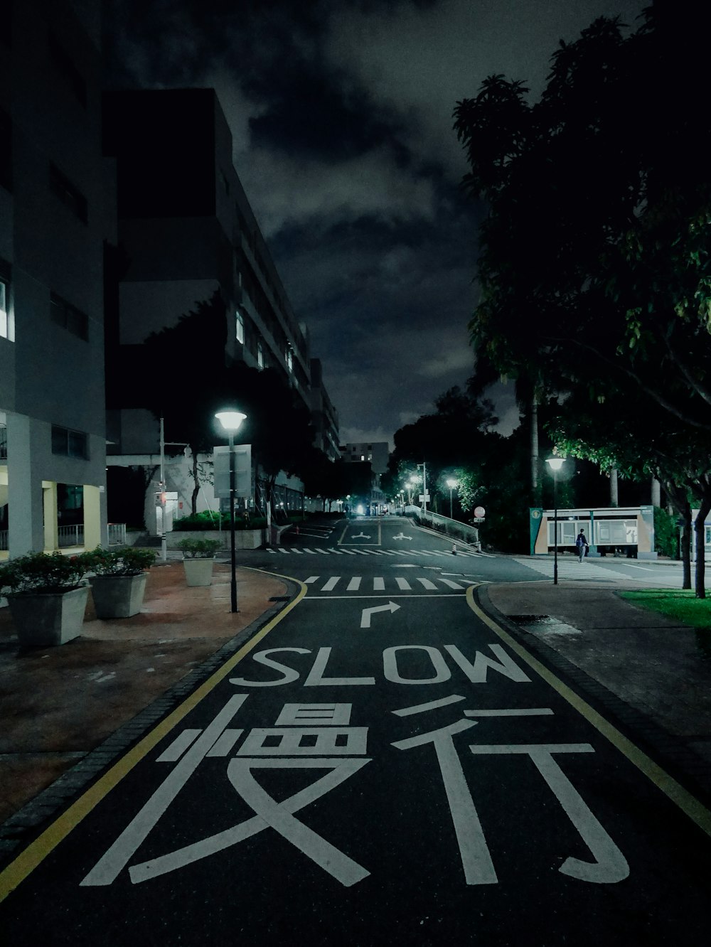 a street at night with a sign painted on the road