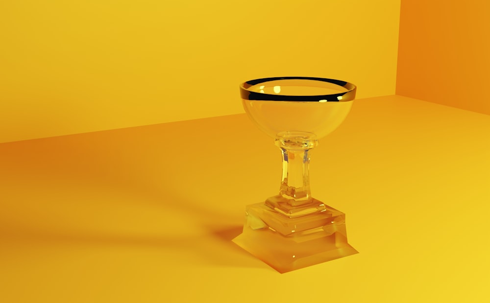 a glass with a black rim on a yellow background