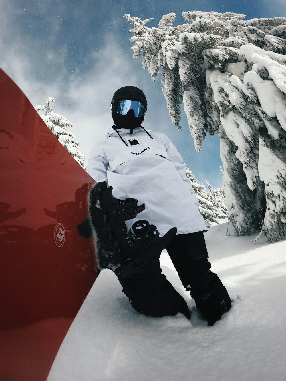 a snowboarder is sitting in the snow with his board