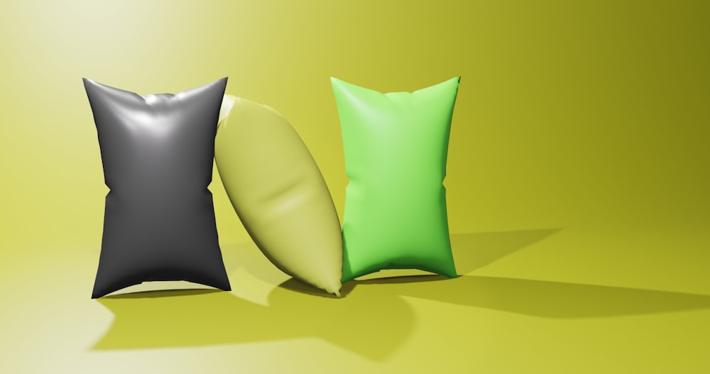 a group of three pillows sitting next to each other