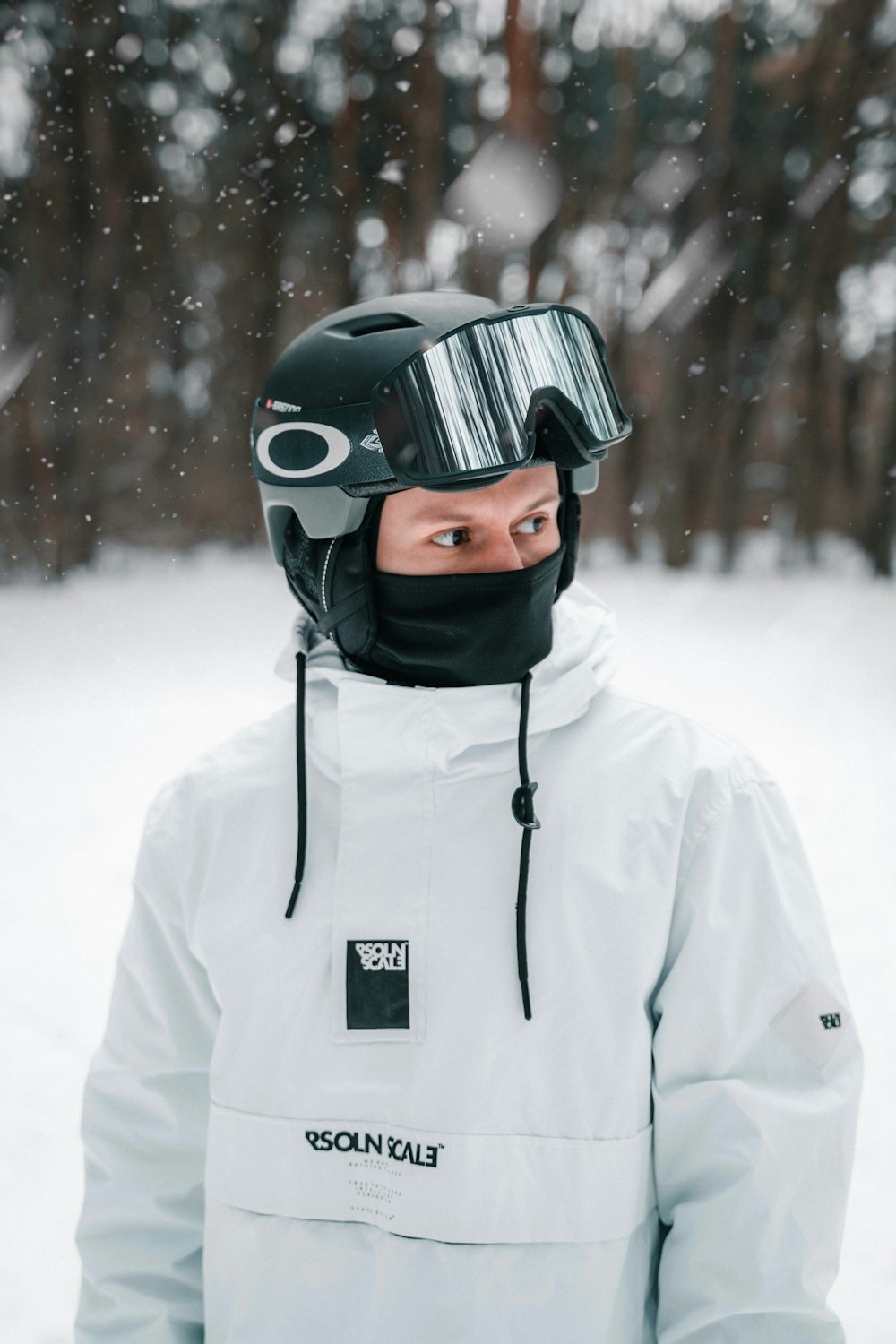 a man wearing a helmet and goggles in the snow