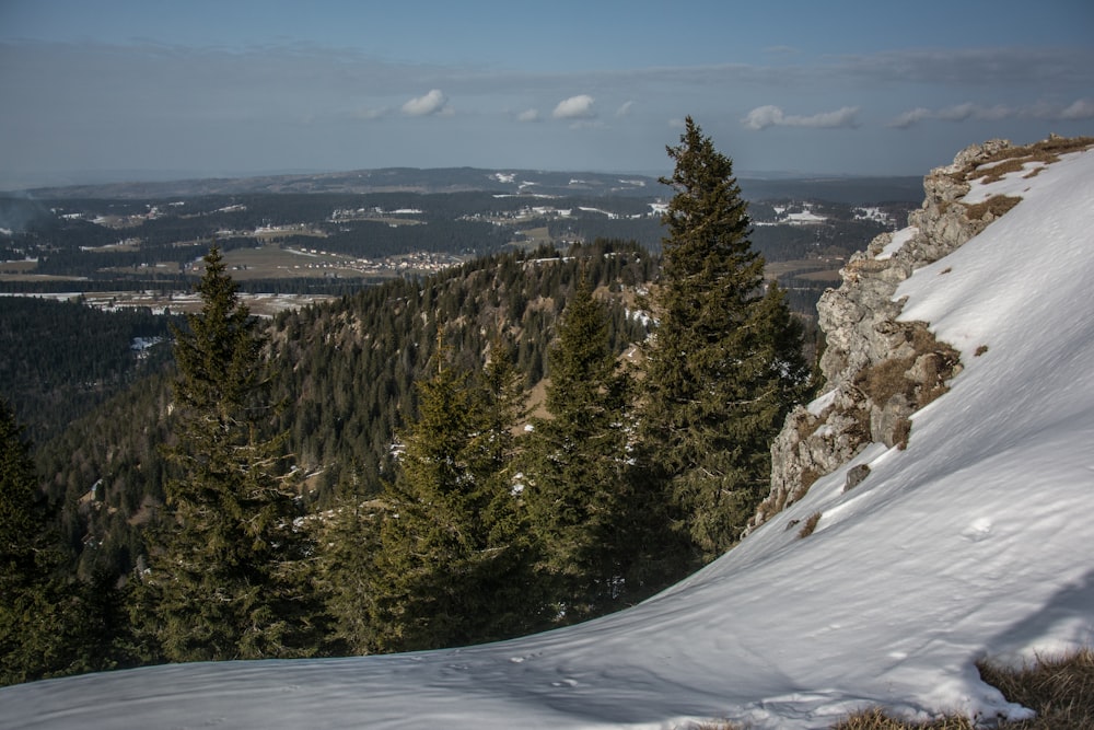 a snowboarder is going down a snowy hill