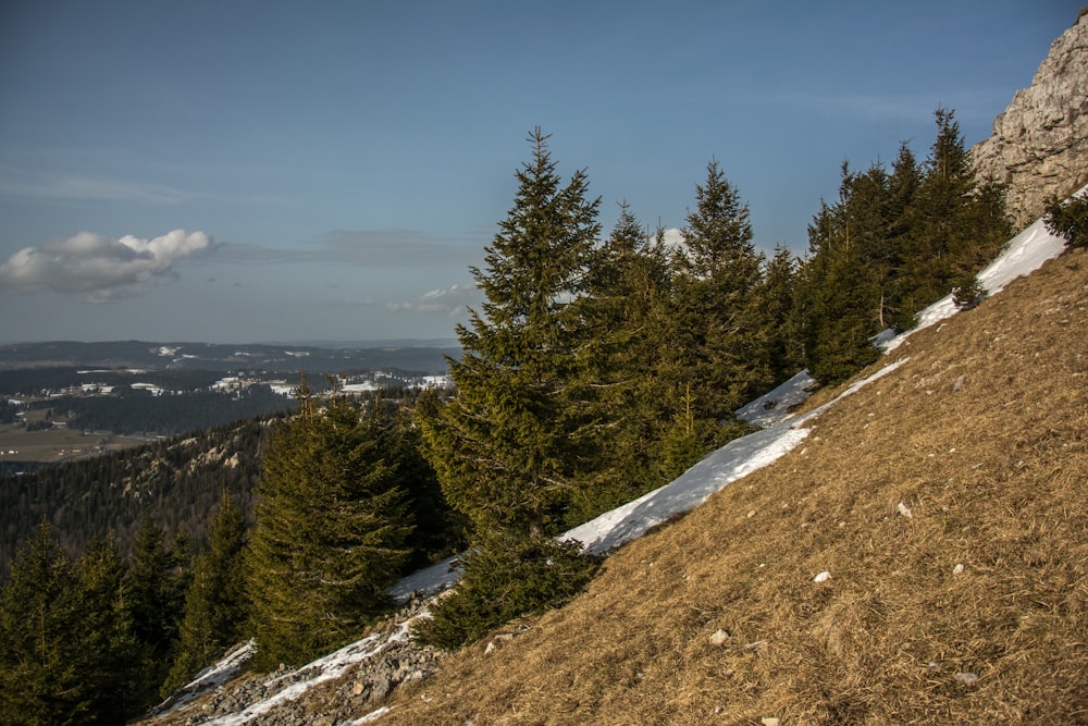 a man riding a snowboard down a snow covered slope