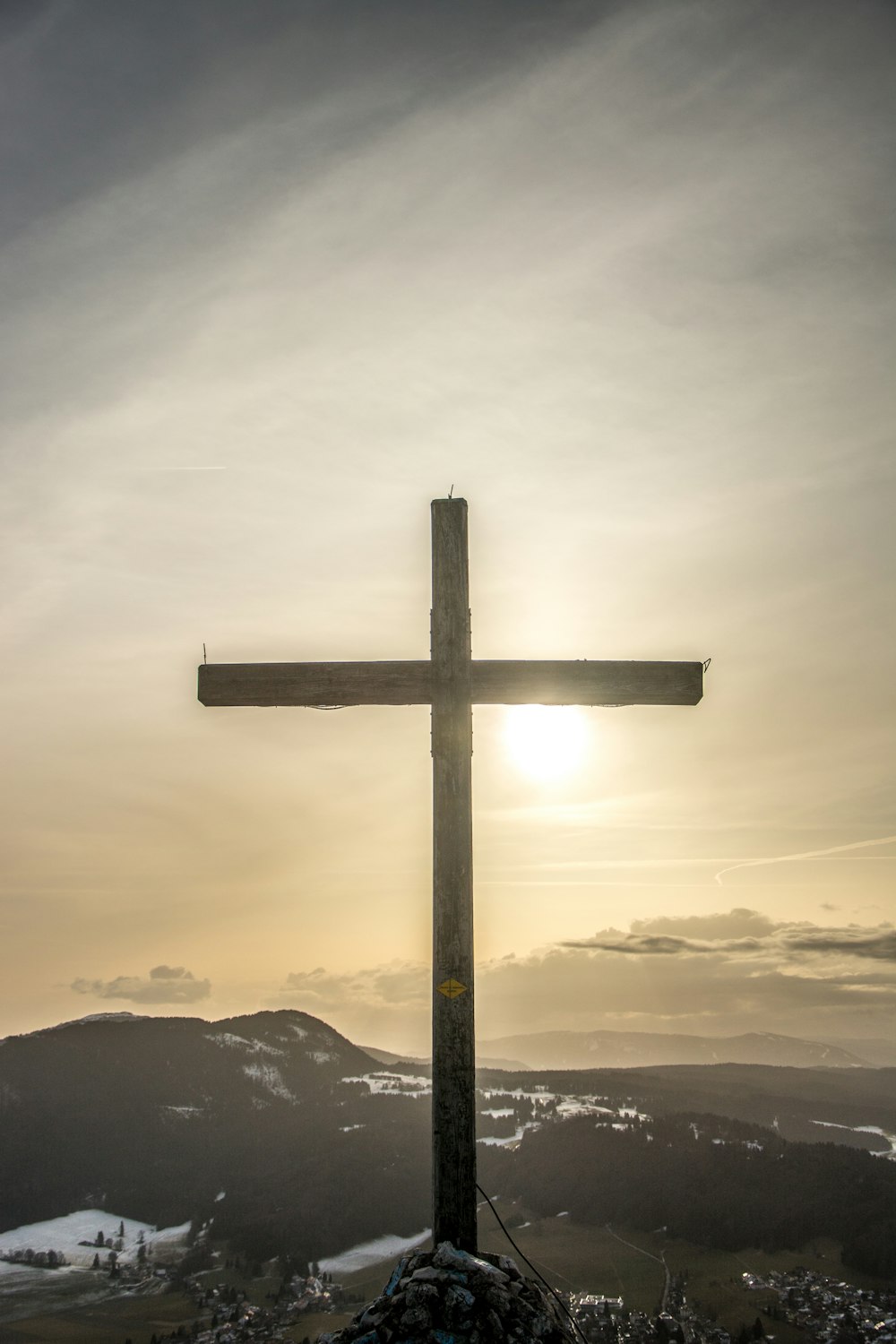 a wooden cross on top of a mountain
