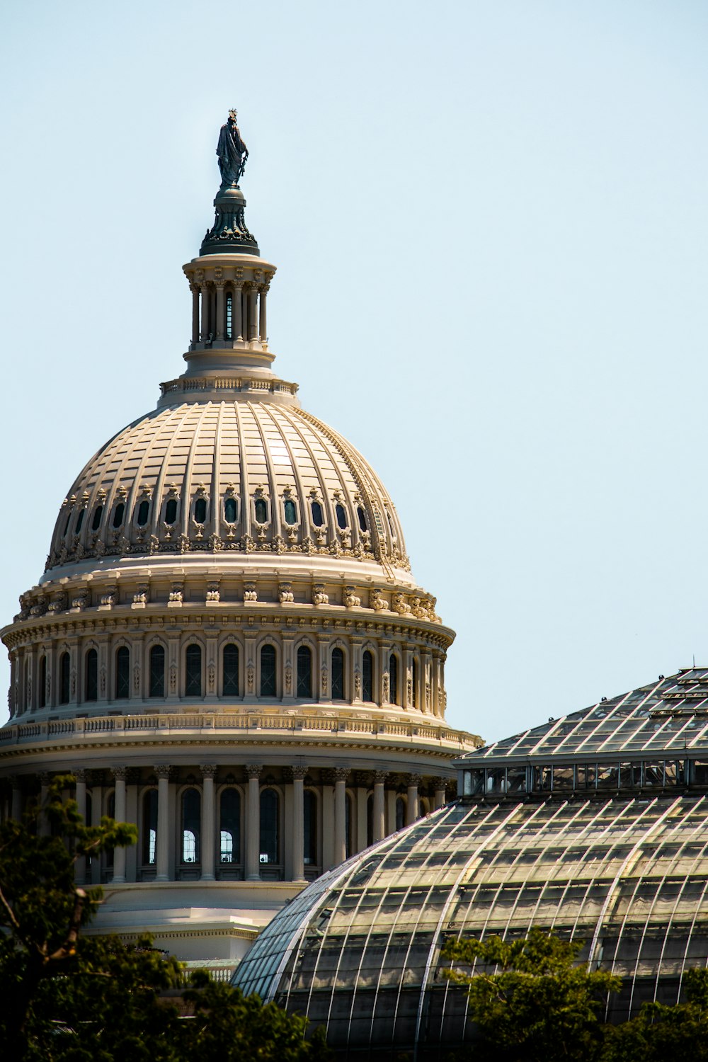 the dome of a building with a statue on top