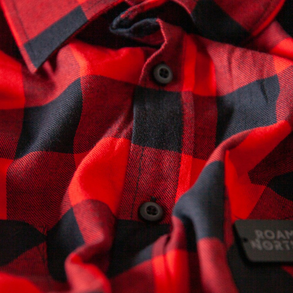 a close up of a red and black plaid shirt