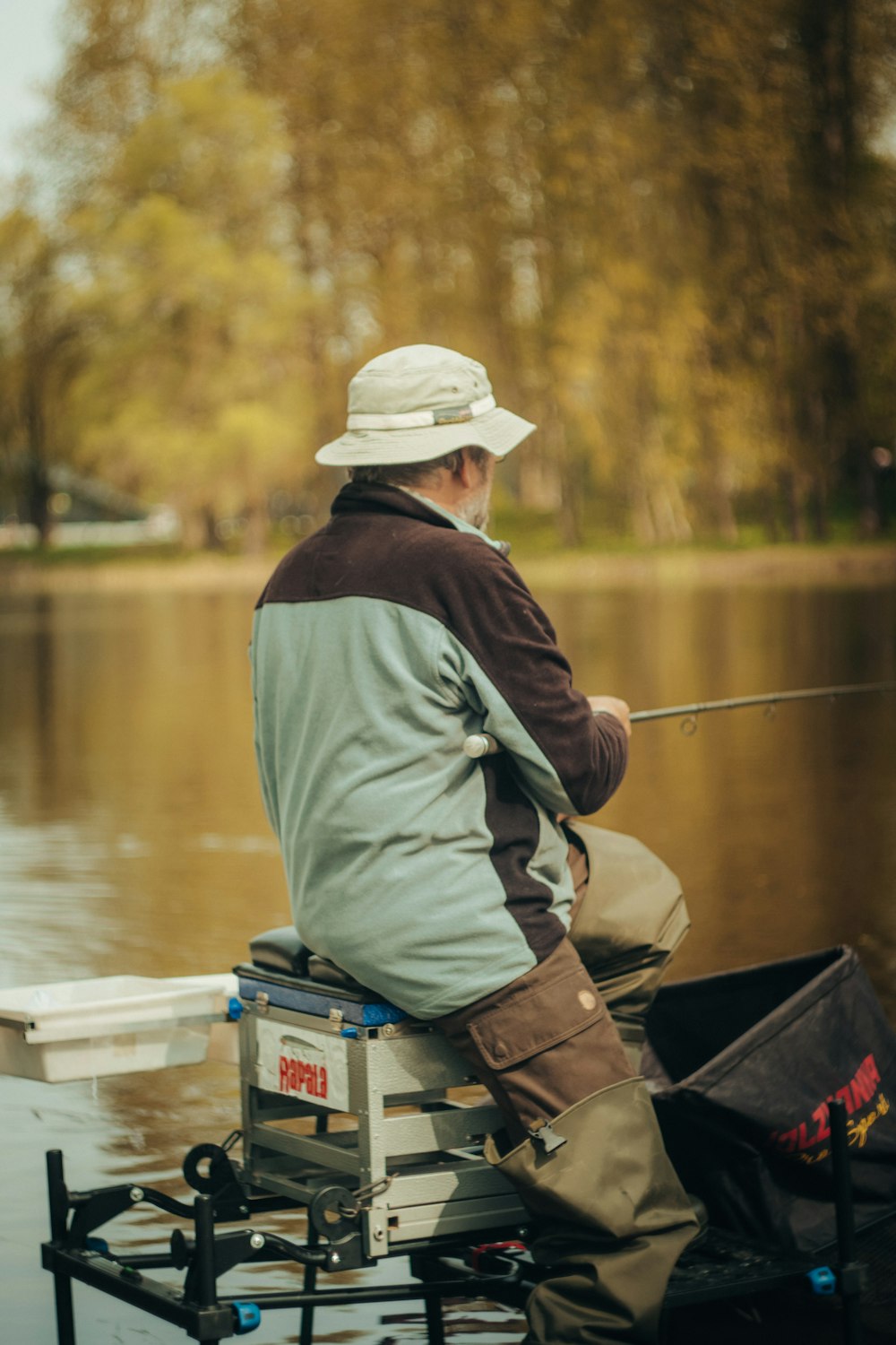 a man sitting on top of a boat while fishing
