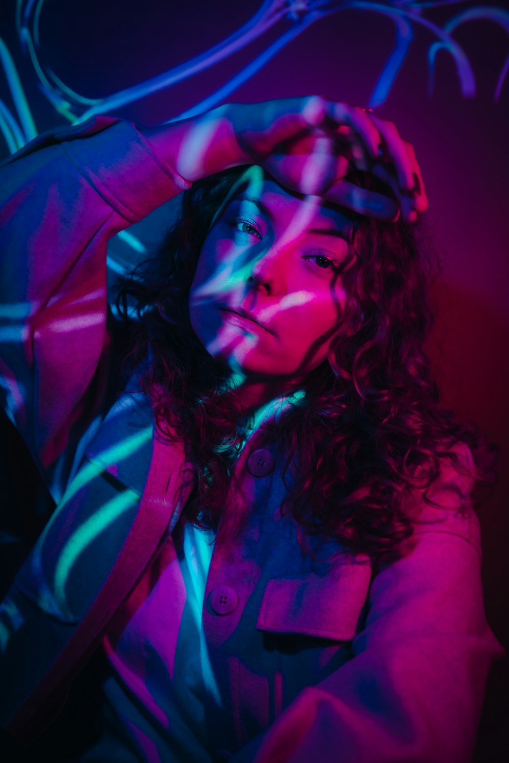 a woman with curly hair is posing for a photo