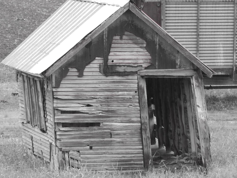 a black and white photo of an old shack