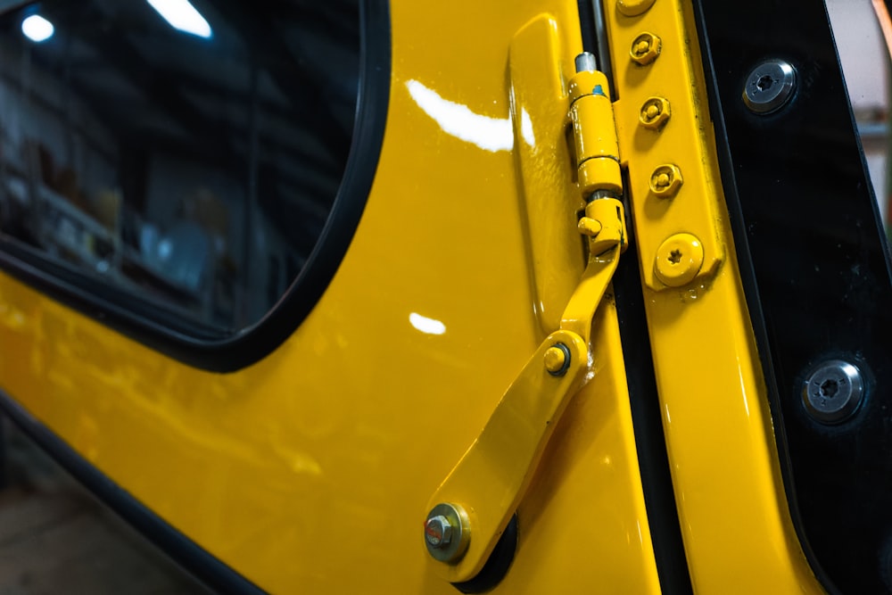 a close up of a yellow door handle on a vehicle