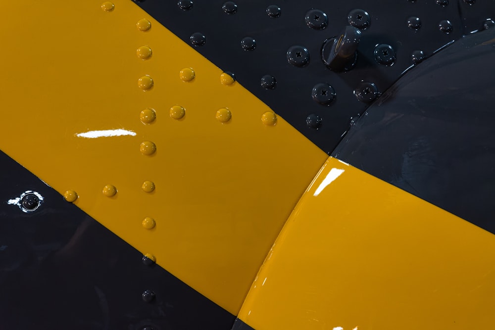 a close up of a yellow and black airplane