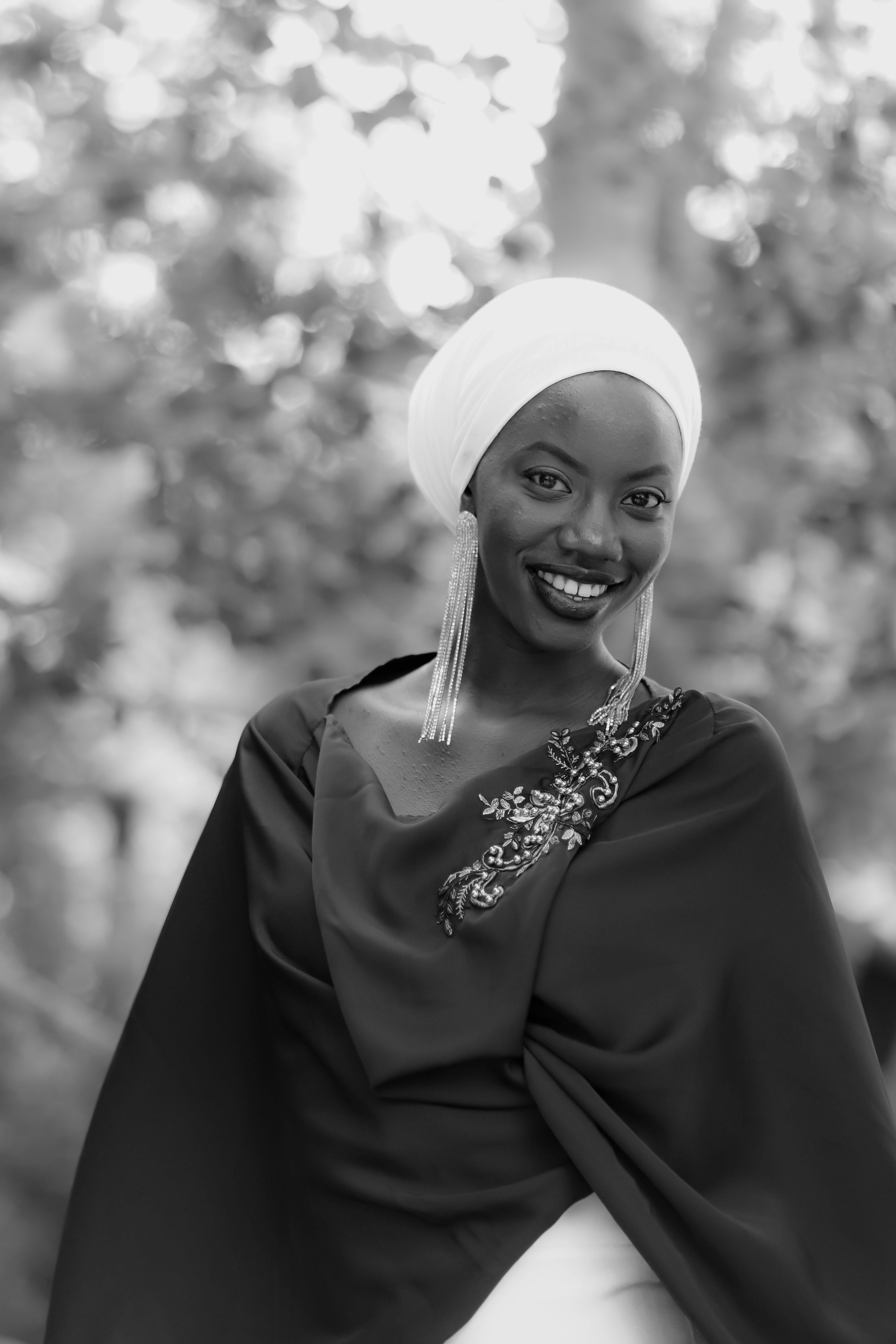 Close-up of a customer smiling warmly, draped in a richly embroidered dupatta from hunar élan.