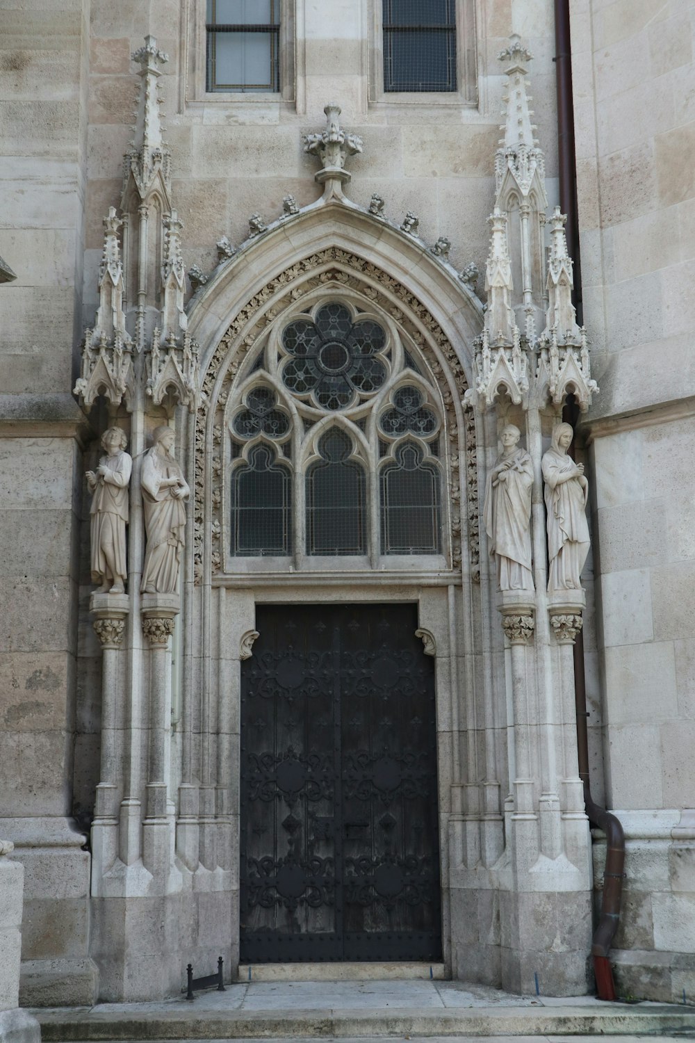 a large stone building with a black door