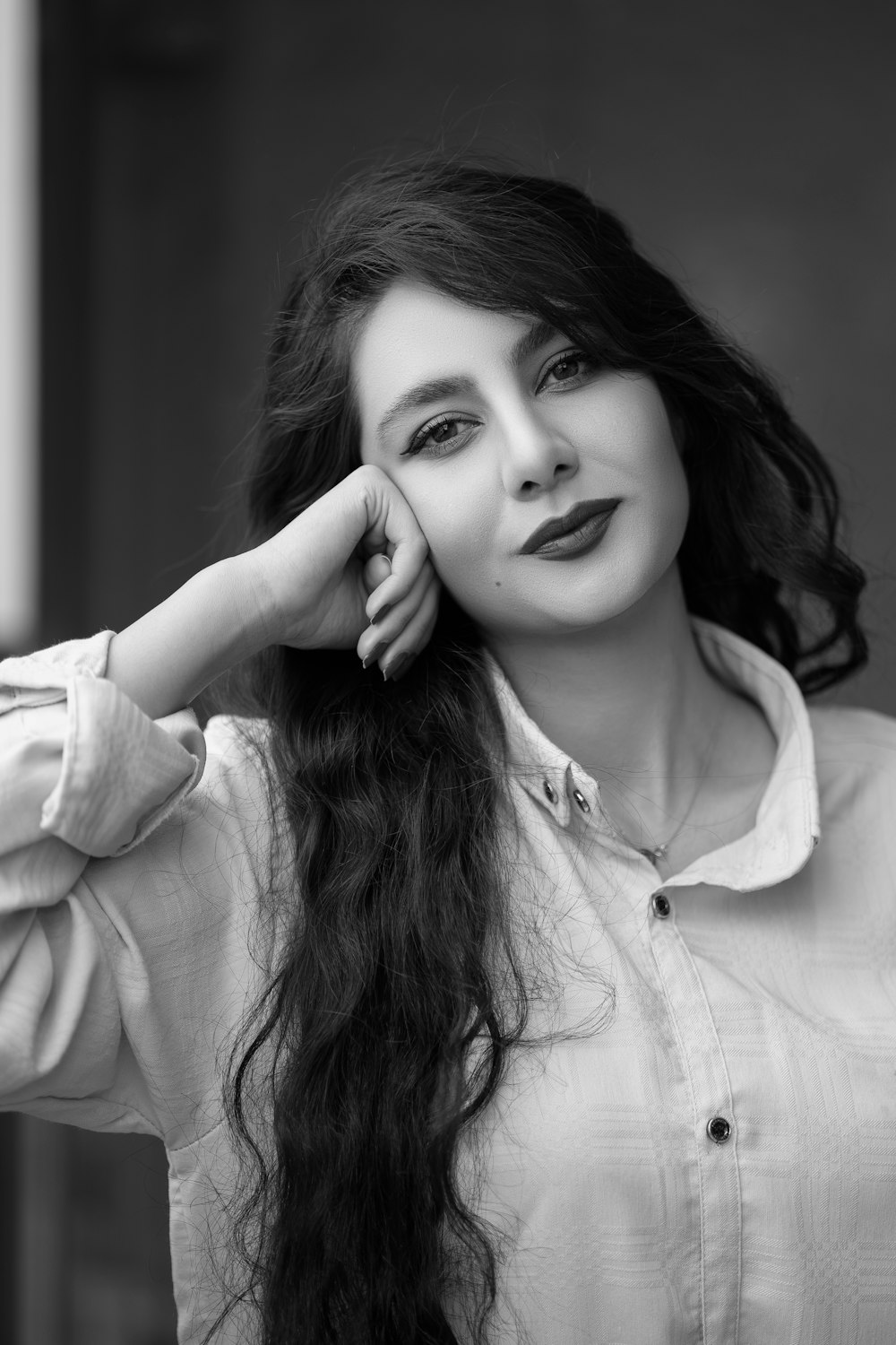 a black and white photo of a woman with long hair