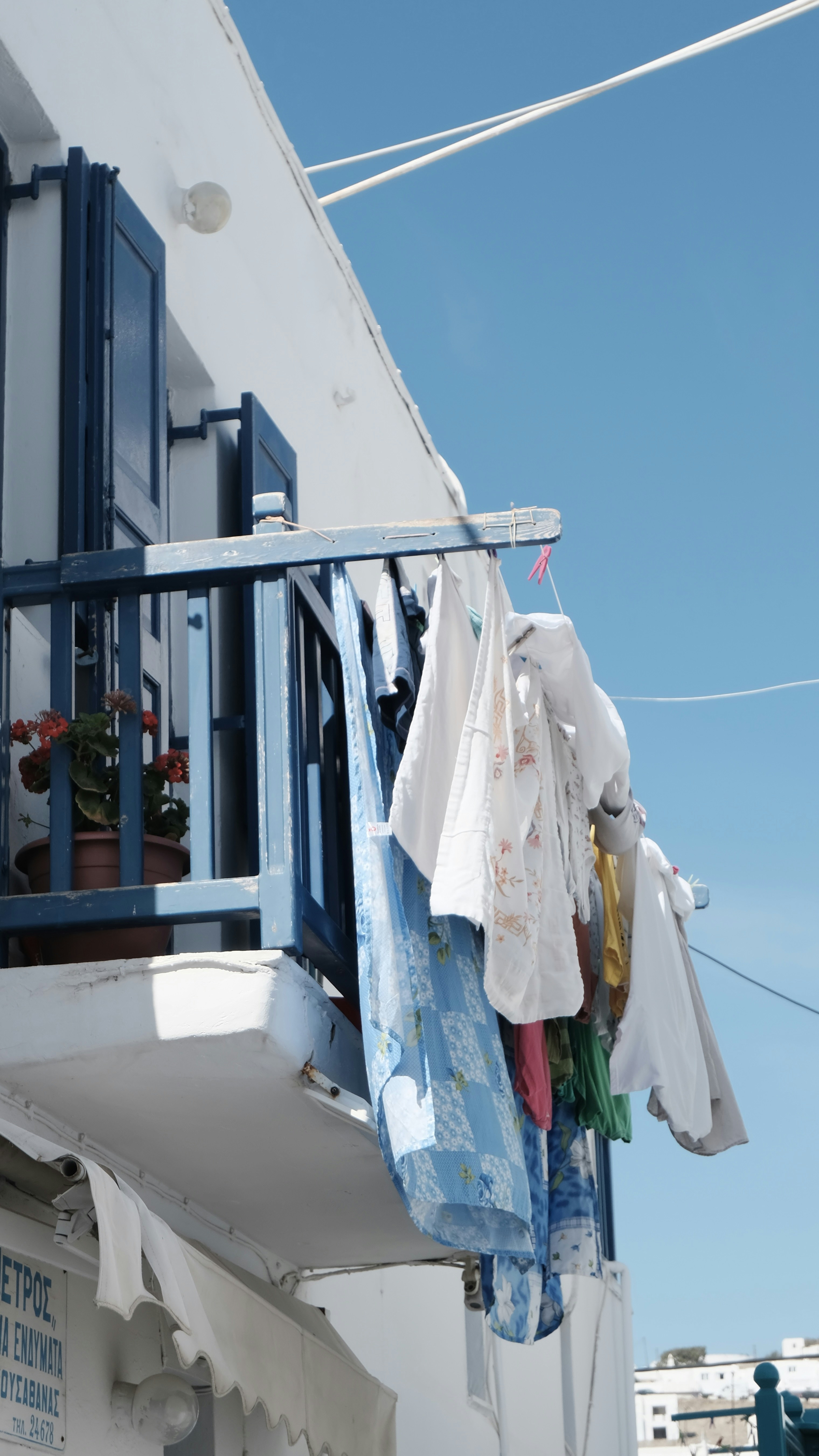 a row of clothes on a line on a balcony