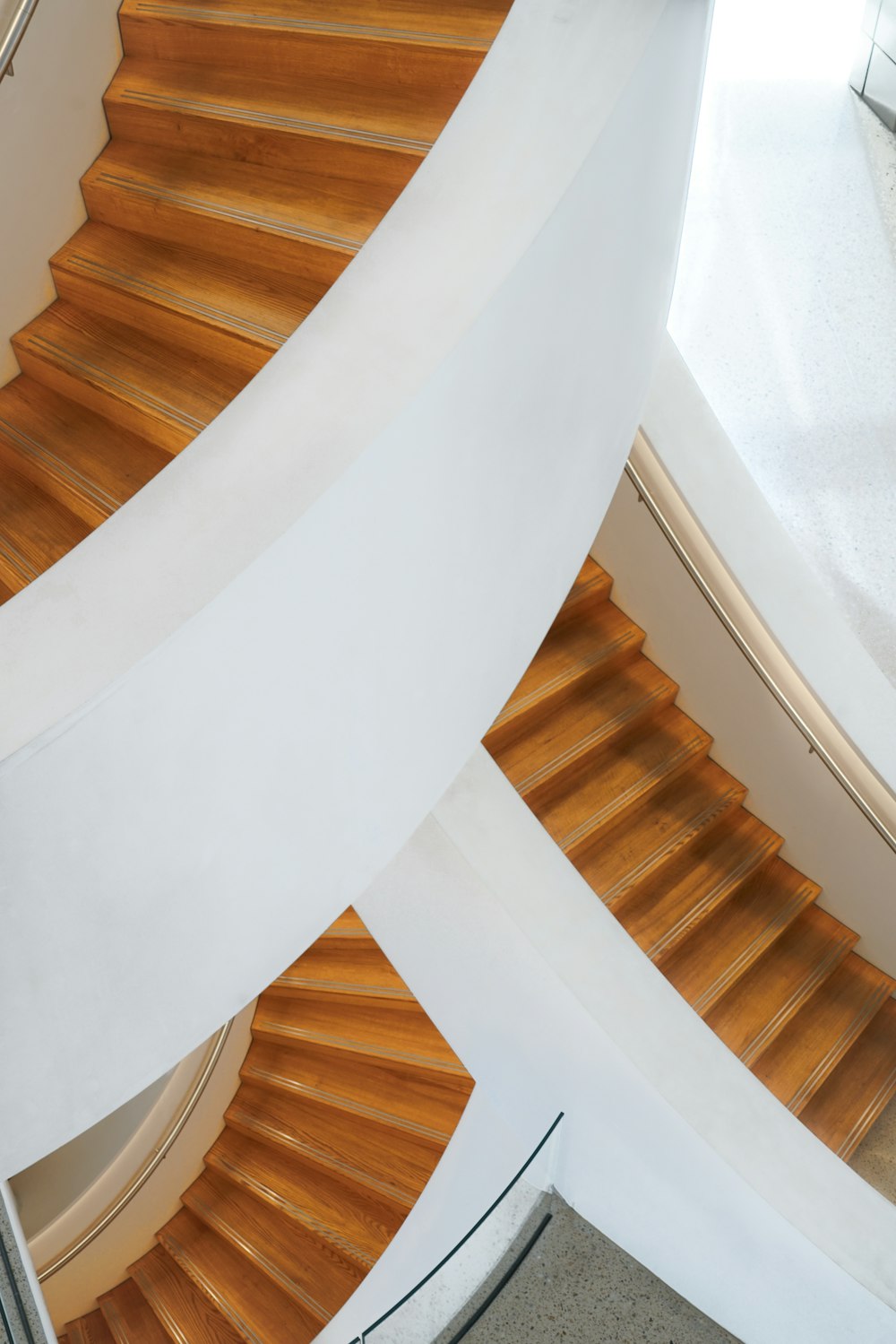 a white staircase with wooden railings