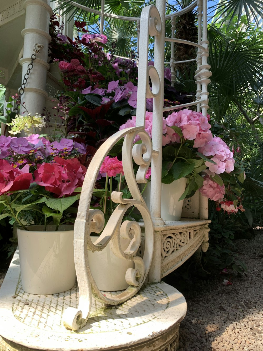 a white vase with pink flowers