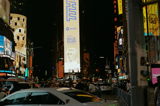 Bright LED billboards and outdoor advertising panels illuminated at night in urban settings.