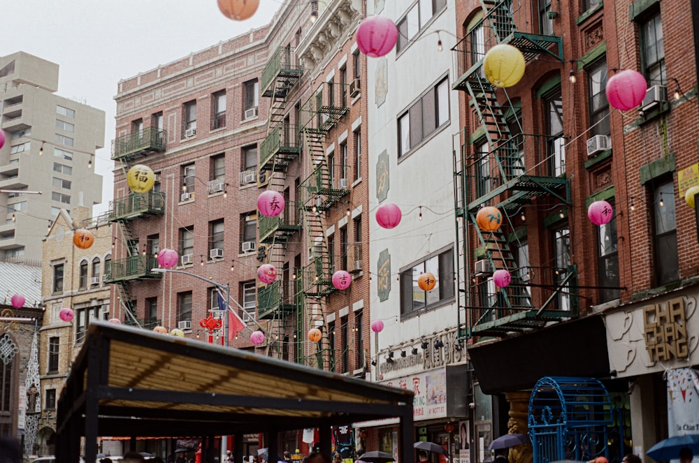 a street with buildings and balloons