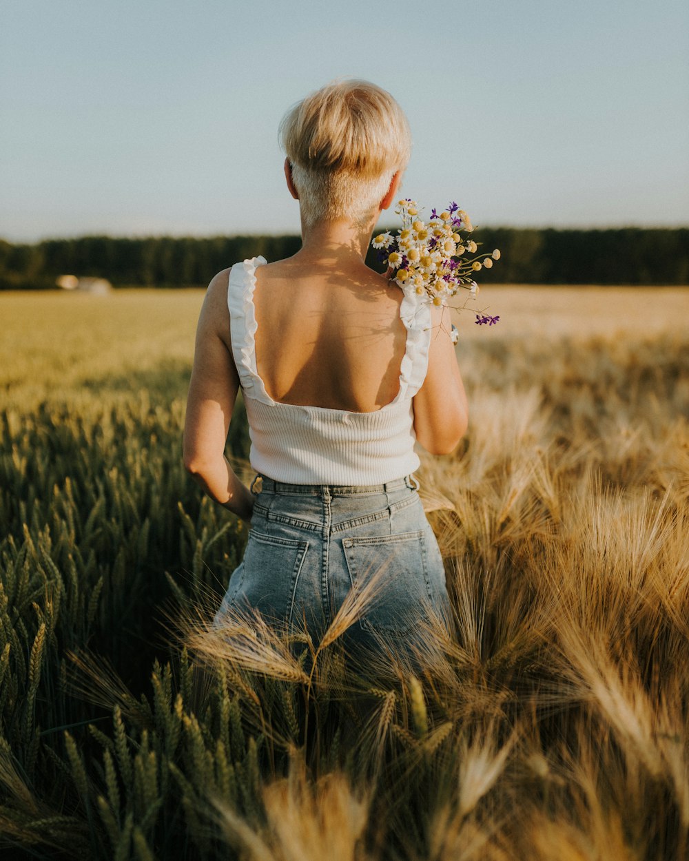 a person standing in a field of wheat