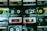 A collection of vintage cassette tapes is neatly arranged in rows, showcasing different brands such as Memorex, Sony, and TDK. Each tape displays handwritten labels with artist names and titles, reflecting a nostalgic appreciation for analog music formats.