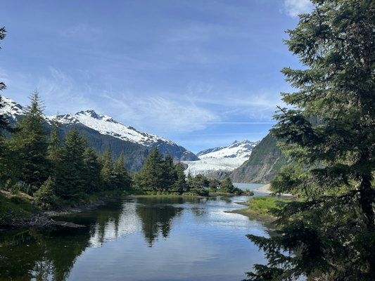 A lake surrounded by trees and mountains — Juneau, United States