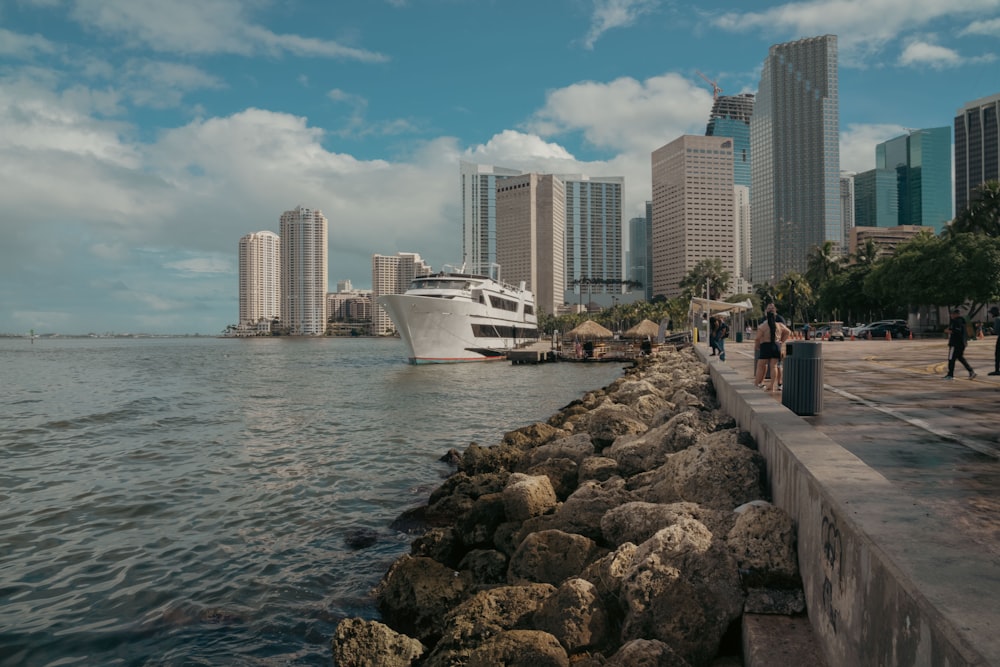 a boat in the water by a city