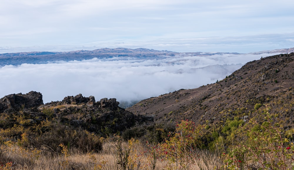 a view of a mountain range and clouds from a distance