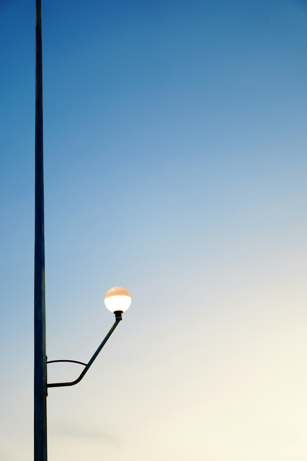 a light post with a blue sky