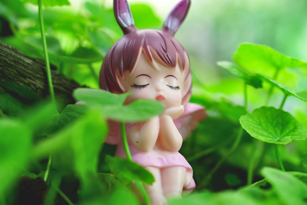 a toy figurine in a plant